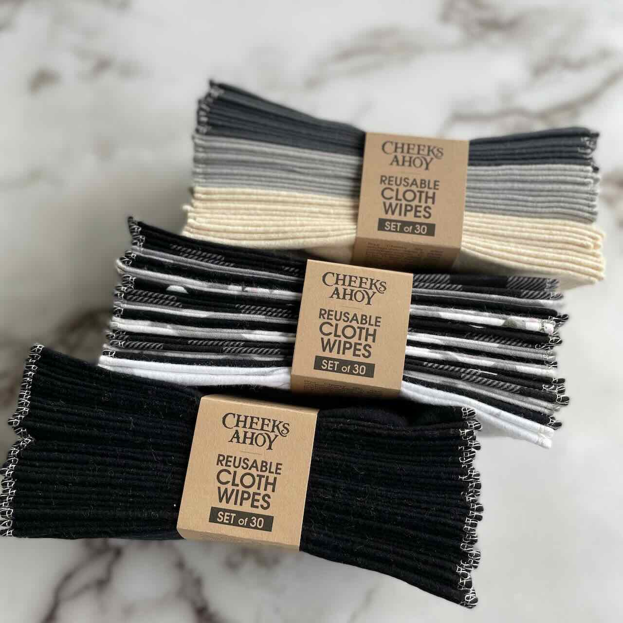 a selection of cheeks ahoy set of 30 reusable cloth wipes on top of marble patterned table top.