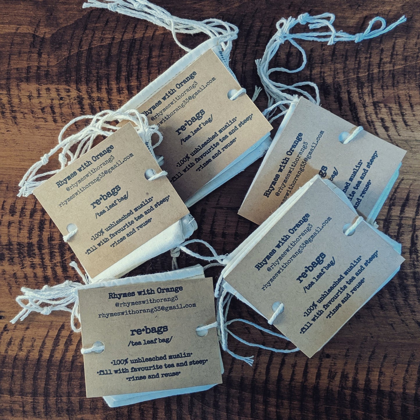 Sets of muslin tea bags on a wooden table top