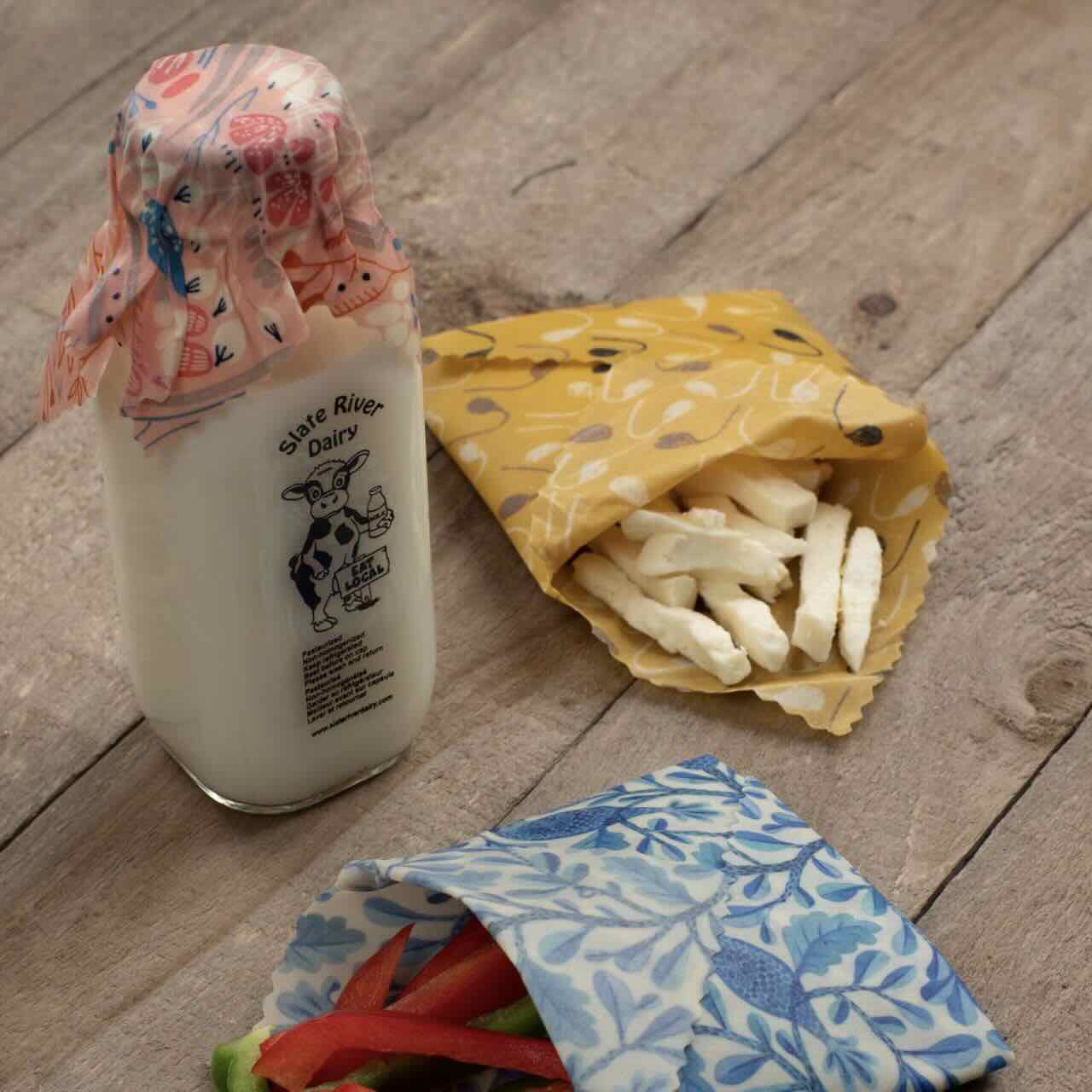 mini beeswax wraps being used to wrap nuts, peppers and milk bottles