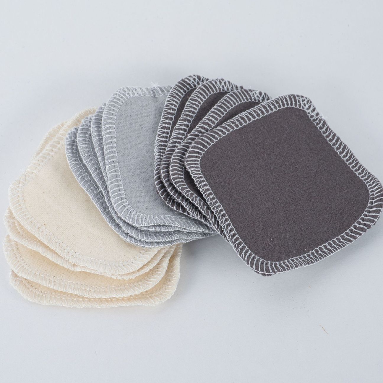 cheeks ahoy set of 12 reusable facial rounds warm neutrals charcoal spread out on a white table  top