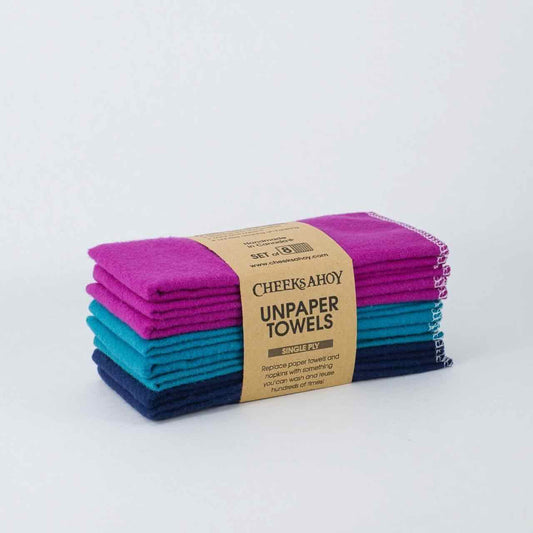 cheeks ahoy selection of purple, blue and navy coloured unpaper towels set of 8 on top of a plain table top.