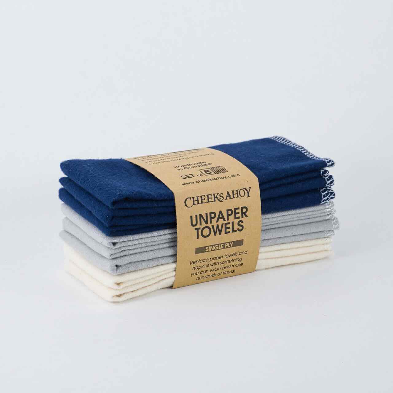cheeks ahoy warm navy unpaper towels set of 8 on top of a plain table top.