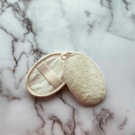 set of 2 loofah shower pads on top of a marble surface