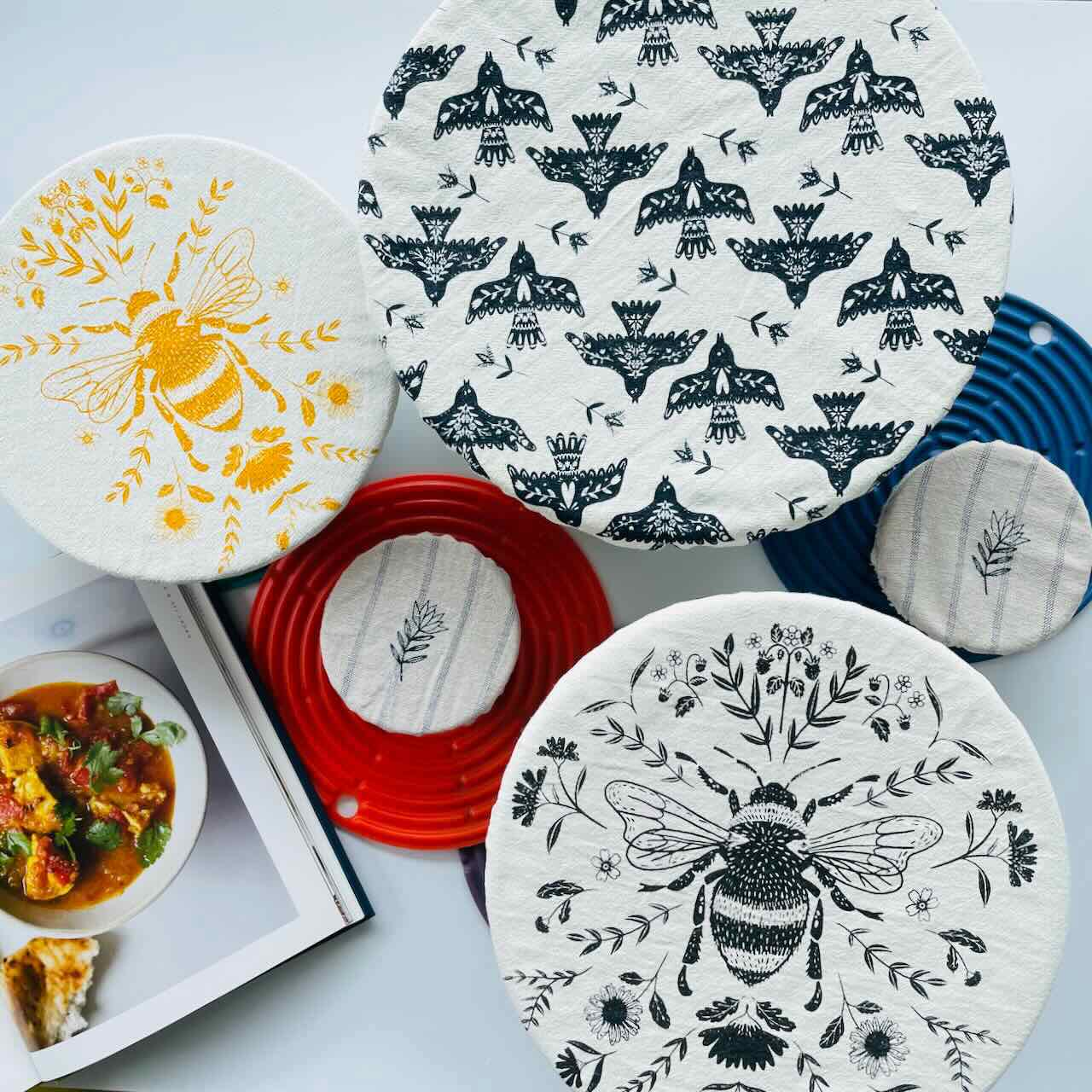 A selection of fabric bowl covers on a white counter top.